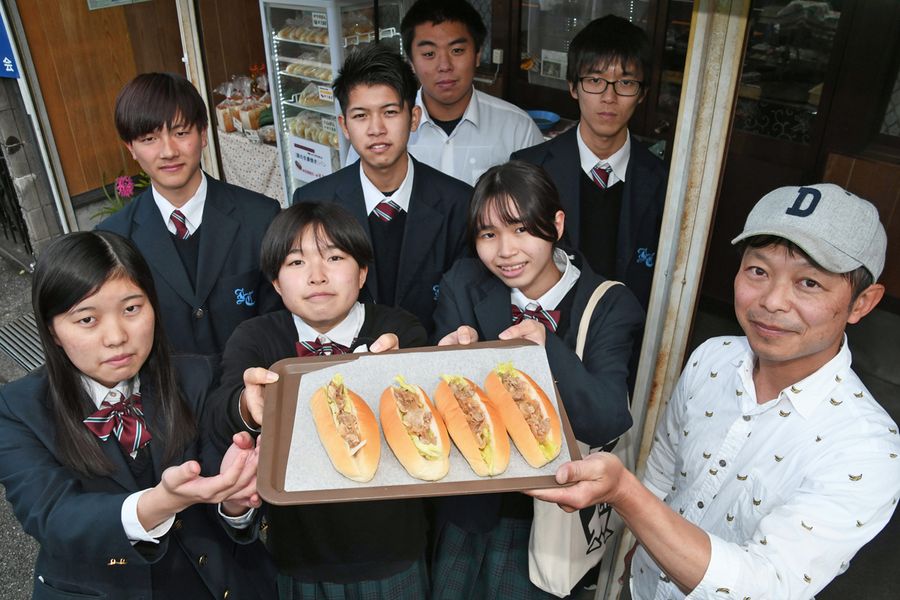 生姜焼きパンを手にする伊野商業高校の生徒ら（いの町の中嶋製パン所）