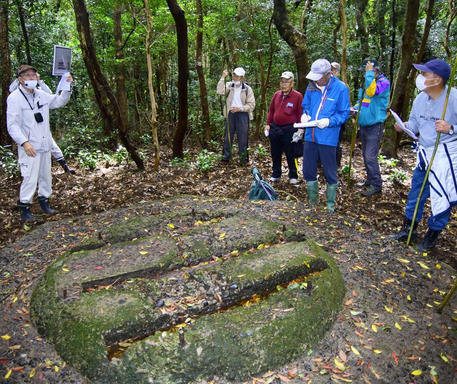 出原恵三さん（左）の解説で、山中に残るレーダー基地跡を見学する参加者＝土佐清水市足摺岬
