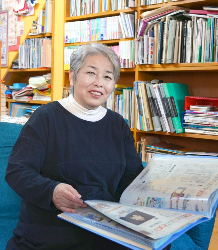高新まんが道場の切り抜きを手に、「皆さん漫画愛がすごい。わが道を行く作品は面白かった」と笑うくさか里樹さん(香美市内の自宅)