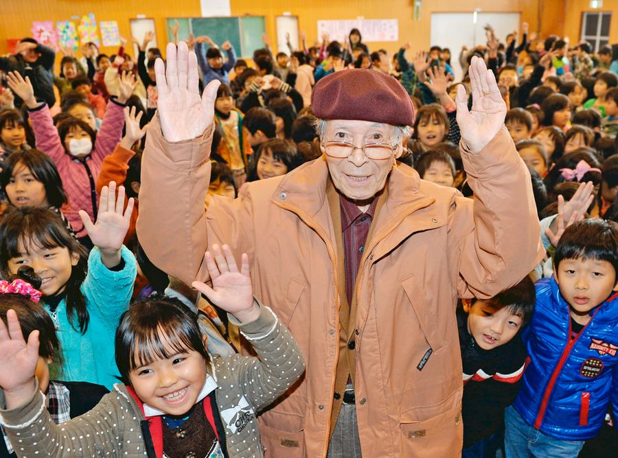 小学校で紙芝居を披露した後、ポーズを決める市原麟一郎さん。「子どもの前に出るのがうれしい」と話していた（２０１３年１２月、高知市の昭和小学校）