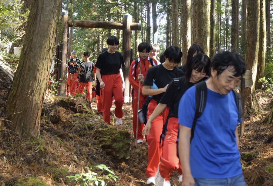 朽木峠の関所跡を越えて元気に歩く高知商業高校２年生の生徒たち（津野町）