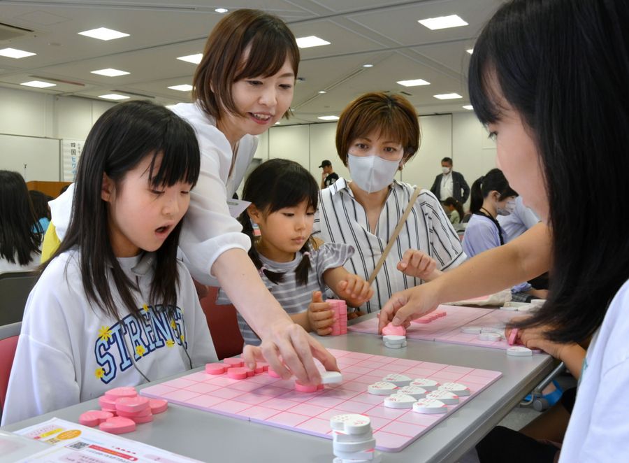女流棋士の島井咲緒里さんの指導を受ける子どもたち(高知市塩屋崎町1丁目の土佐中高校)