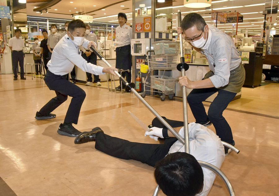 ２人一組でさすまたを使い、強盗役を制圧した（南国市大そね乙）