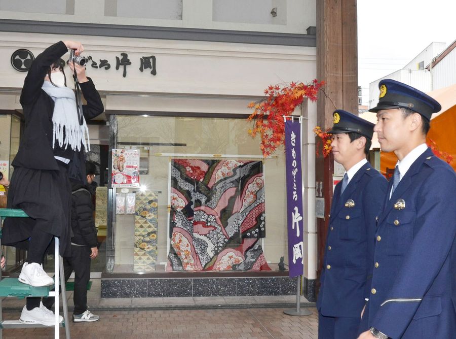 中心商店街で警察官募集ポスターの撮影をする鍋島悠良さん（高知市はりまや町１丁目）