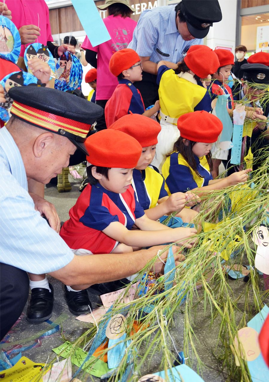 願いを込めた短冊をササに飾り付ける園児ら（ＪＲ高知駅）